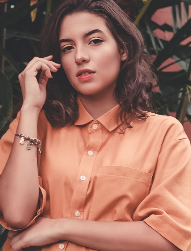 Brunnet young woman with orange shirt